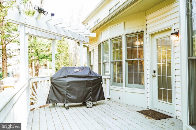 deck with grilling area and a pergola