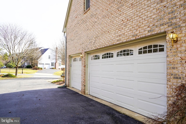 garage featuring aphalt driveway