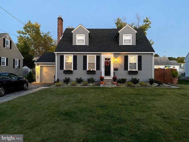 cape cod house featuring driveway, a chimney, an attached garage, fence, and a front yard