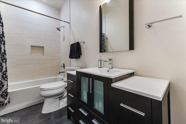 bathroom with vanity, shower / bath combination with curtain, and toilet