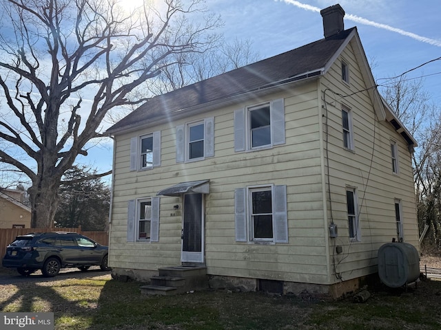 colonial-style house with heating fuel and a chimney