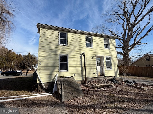 view of front of home featuring fence