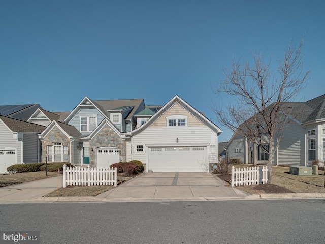 view of front of house with a residential view, stone siding, fence, and driveway