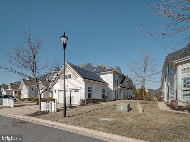 view of property exterior featuring a garage, a residential view, and driveway