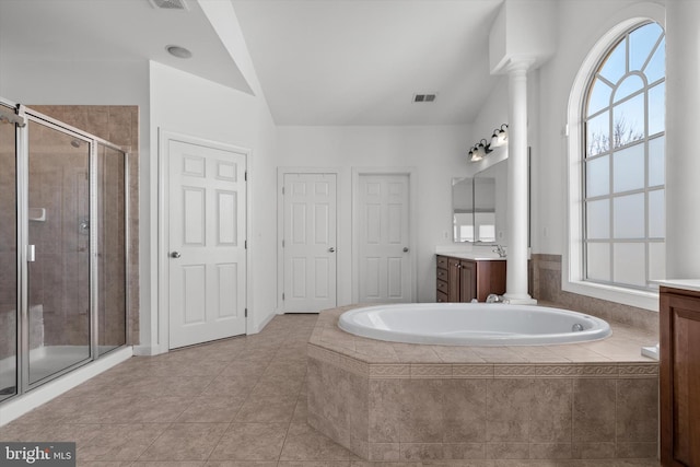 bathroom with a garden tub, a shower stall, and vanity