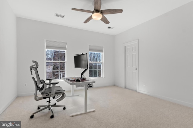 home office featuring a ceiling fan, carpet, visible vents, and baseboards