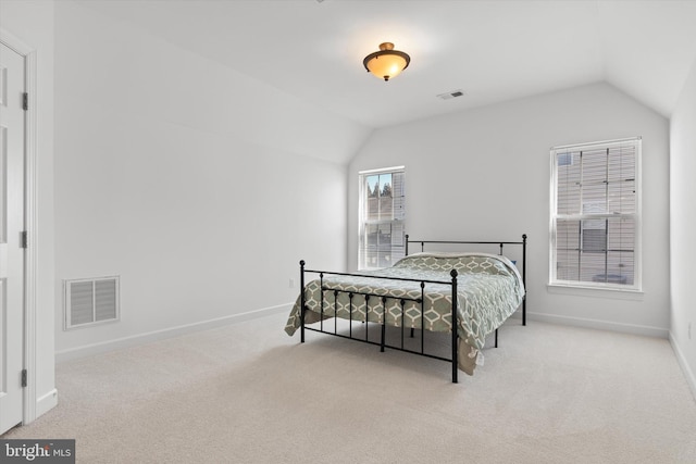 bedroom featuring vaulted ceiling, carpet floors, visible vents, and baseboards