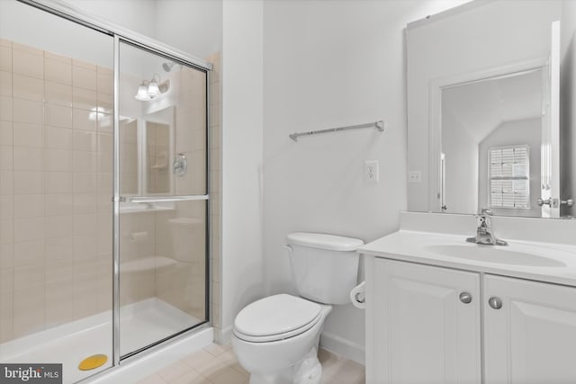 bathroom with a stall shower, baseboards, vanity, and toilet