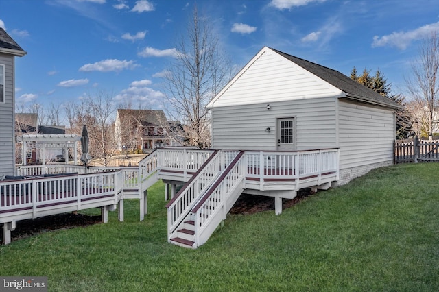 back of property featuring fence, a lawn, a deck, and a pergola