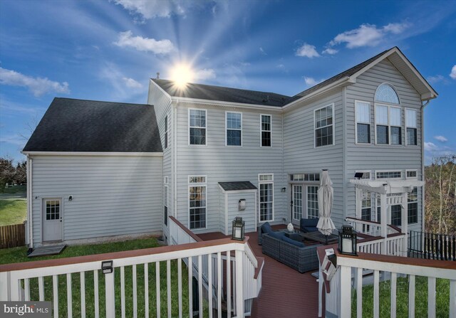 back of house with a deck and outdoor lounge area