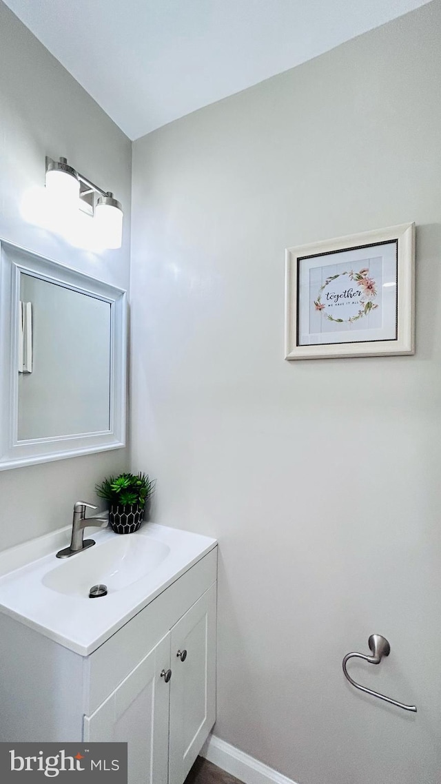 bathroom with vanity and baseboards