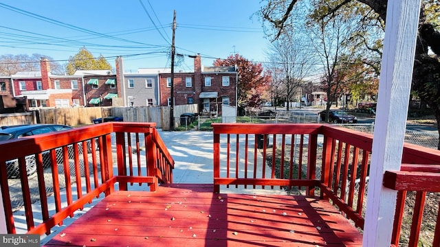 deck with a residential view and fence