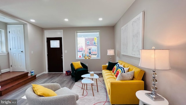 living room with recessed lighting, baseboards, and wood finished floors