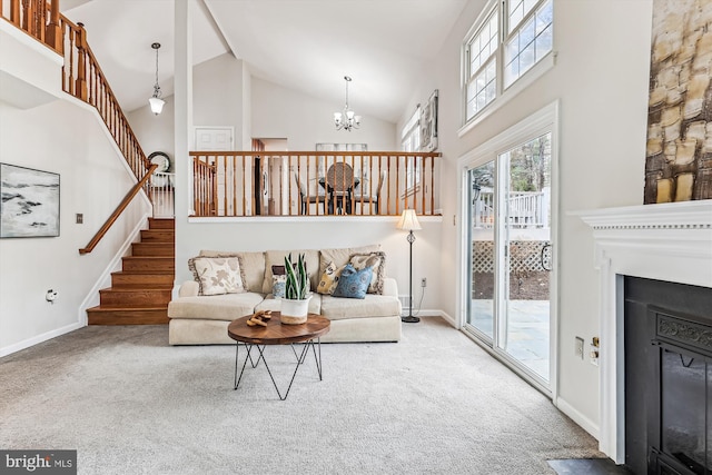 carpeted living area featuring an inviting chandelier, a fireplace, baseboards, and high vaulted ceiling