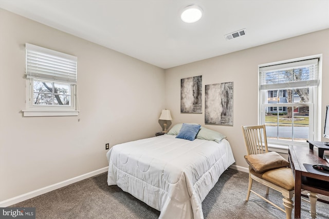 bedroom with visible vents, multiple windows, and carpet