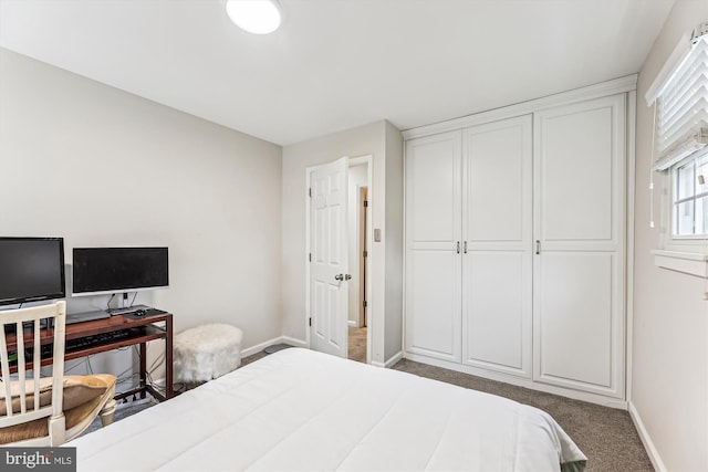 bedroom featuring a closet, carpet flooring, and baseboards