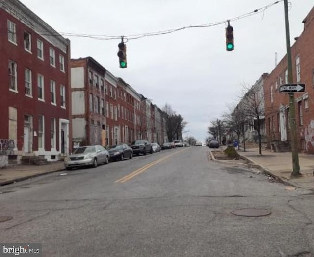 view of road with sidewalks, traffic lights, and curbs