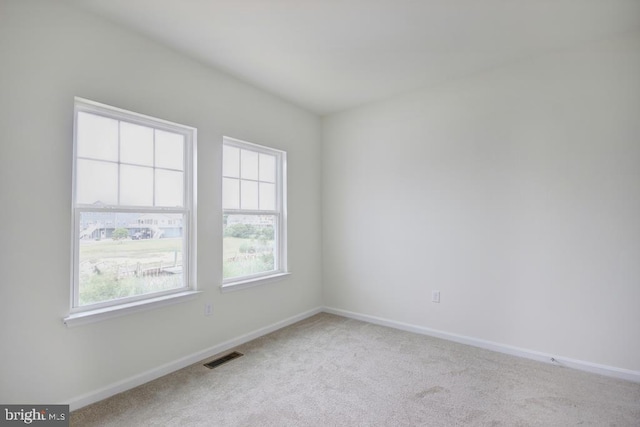 unfurnished room featuring light carpet, baseboards, and visible vents