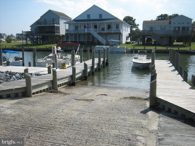 view of dock featuring a residential view and a water view