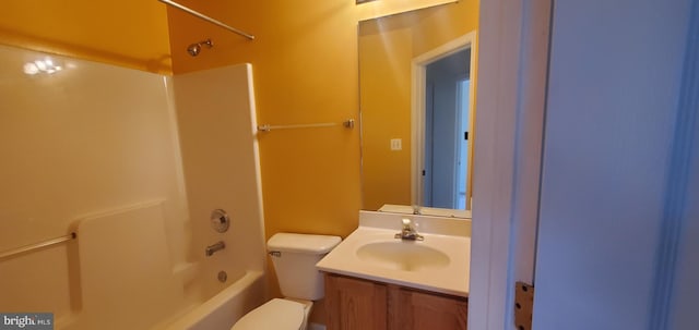 bathroom with shower / tub combination, vanity, and toilet