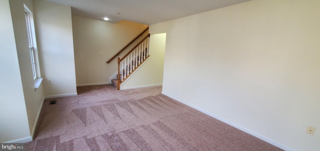 spare room featuring recessed lighting, light colored carpet, visible vents, stairway, and baseboards