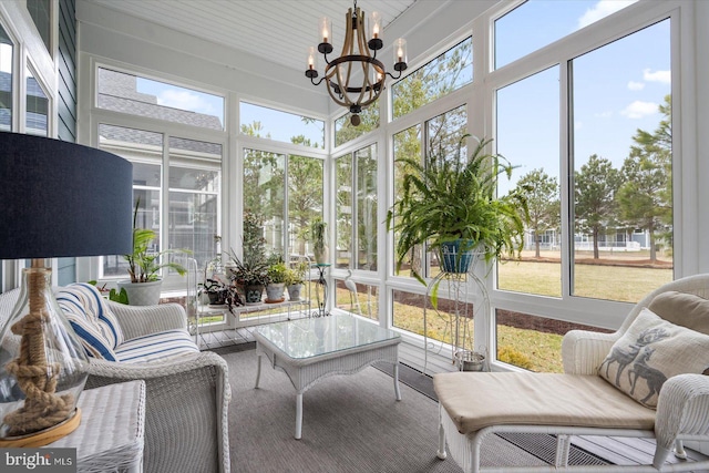 sunroom / solarium with a chandelier