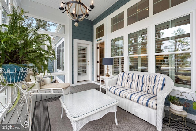 sunroom featuring a chandelier