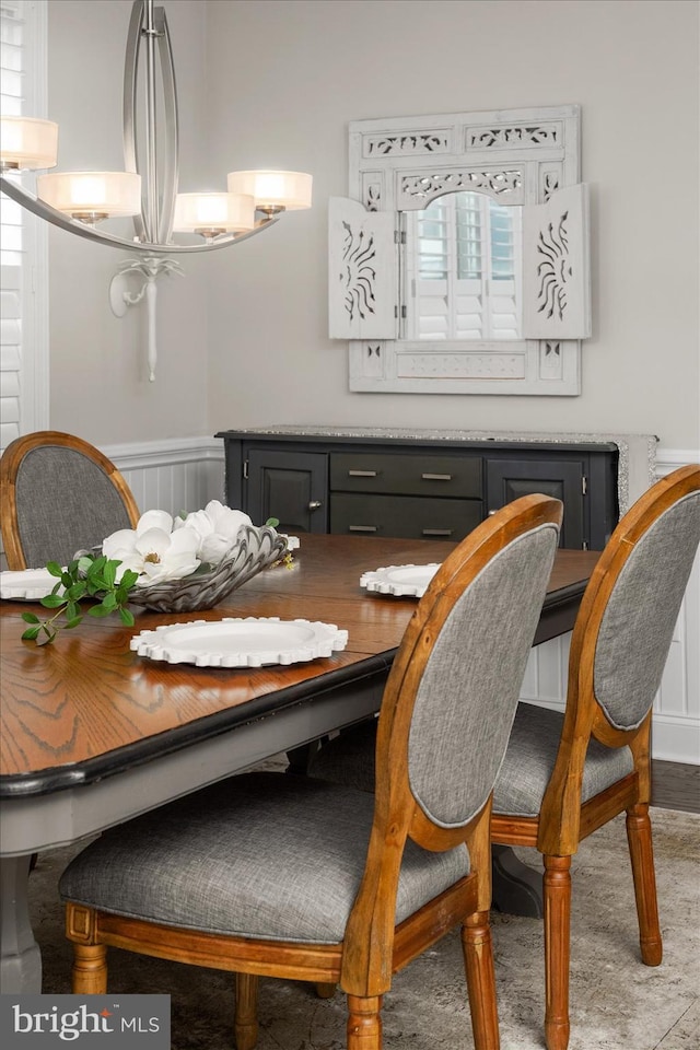 dining space featuring wainscoting