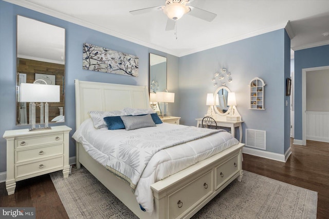 bedroom featuring visible vents, crown molding, baseboards, a ceiling fan, and dark wood-style flooring