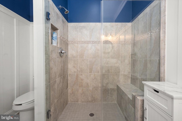 full bath featuring a shower stall and toilet