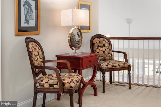 sitting room featuring carpet flooring and baseboards