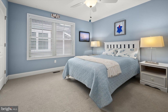 bedroom featuring a ceiling fan, carpet, visible vents, and baseboards