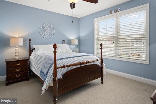 carpeted bedroom featuring baseboards and ceiling fan