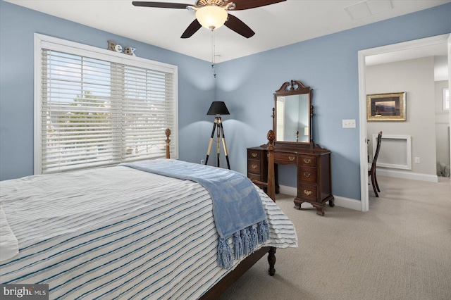 bedroom featuring visible vents, light colored carpet, a ceiling fan, and baseboards