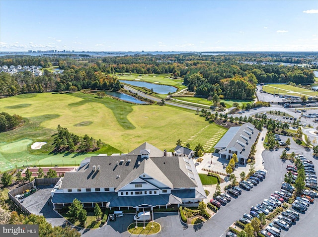 drone / aerial view with a water view and view of golf course