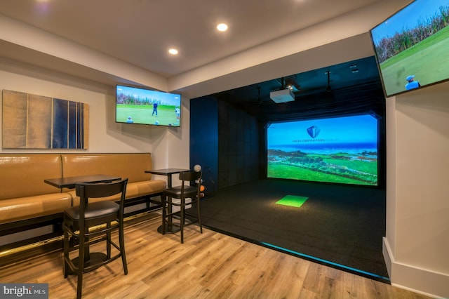 rec room with golf simulator, wood finished floors, and recessed lighting