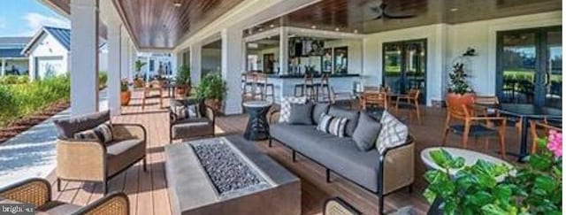 view of patio featuring an outdoor living space with a fire pit