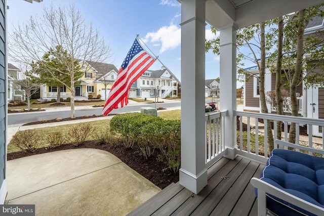 wooden terrace with a residential view and covered porch