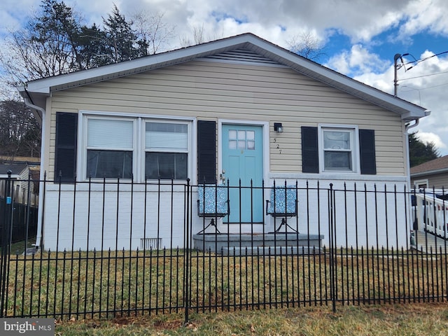 bungalow-style house with a fenced front yard