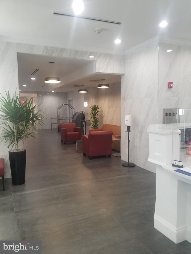 community lobby featuring tile walls and crown molding