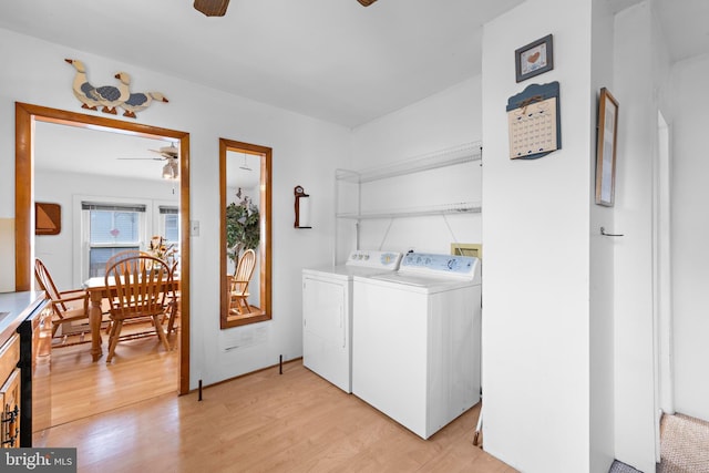 laundry area with light wood-type flooring, ceiling fan, and washer and dryer