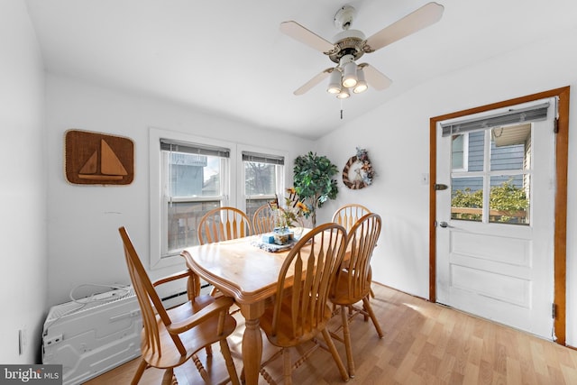 dining space featuring a ceiling fan, lofted ceiling, and light wood-style flooring