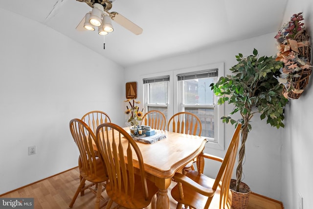 dining space featuring lofted ceiling, a ceiling fan, and wood finished floors