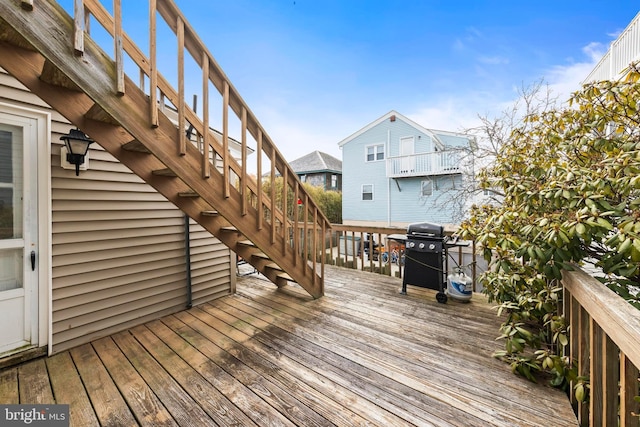 wooden terrace featuring stairs and grilling area