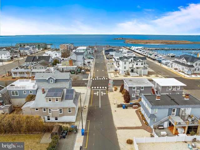 drone / aerial view featuring a residential view and a water view