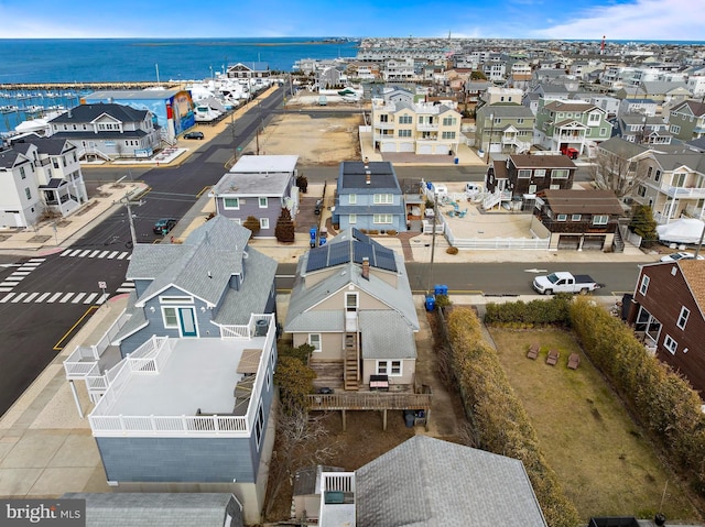 drone / aerial view with a residential view and a water view