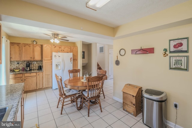 dining room with light tile patterned floors, visible vents, stairway, a ceiling fan, and a textured ceiling