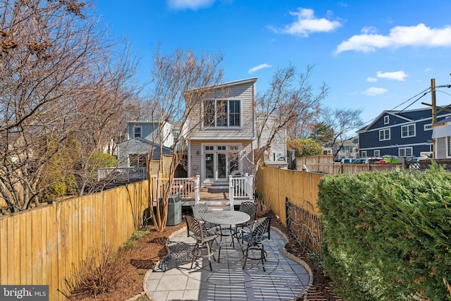 rear view of house with a residential view, a patio area, a fenced backyard, and a deck