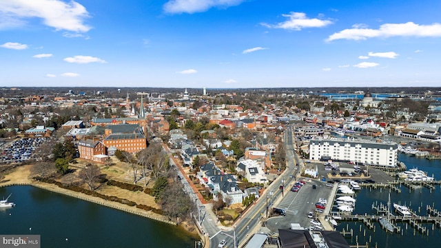 birds eye view of property with a water view and a city view