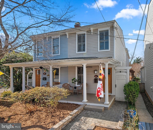 view of front of property with a chimney and a porch